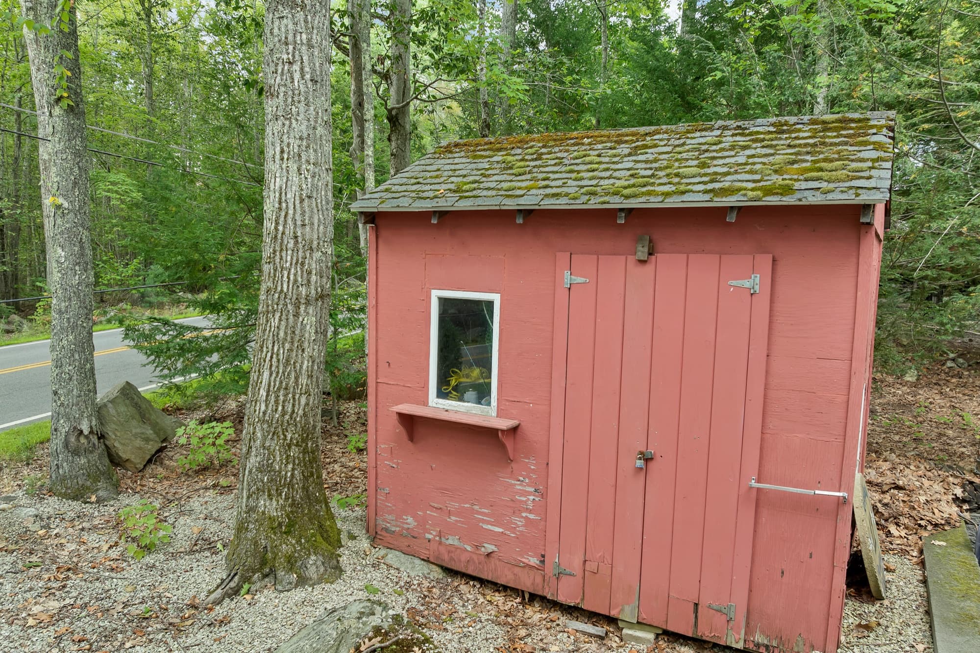 The red storage shed with its window and double doors