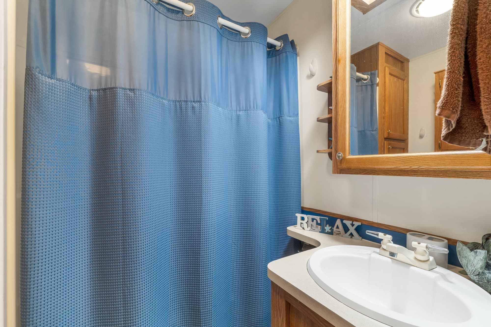 The full bath with the vanity, mirror, and tub and shower
