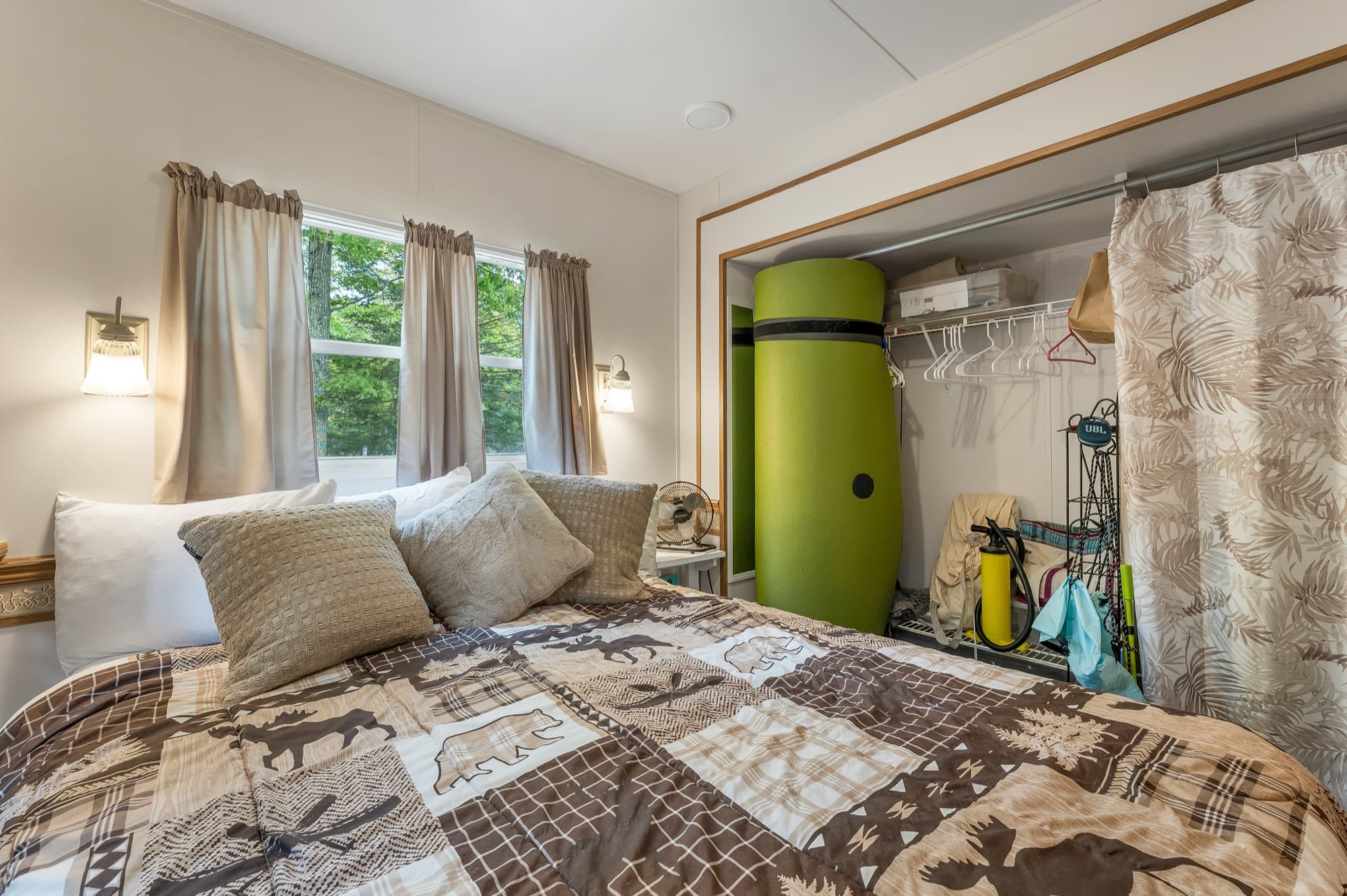 The bedroom with the closet and the sliding door to the living area
