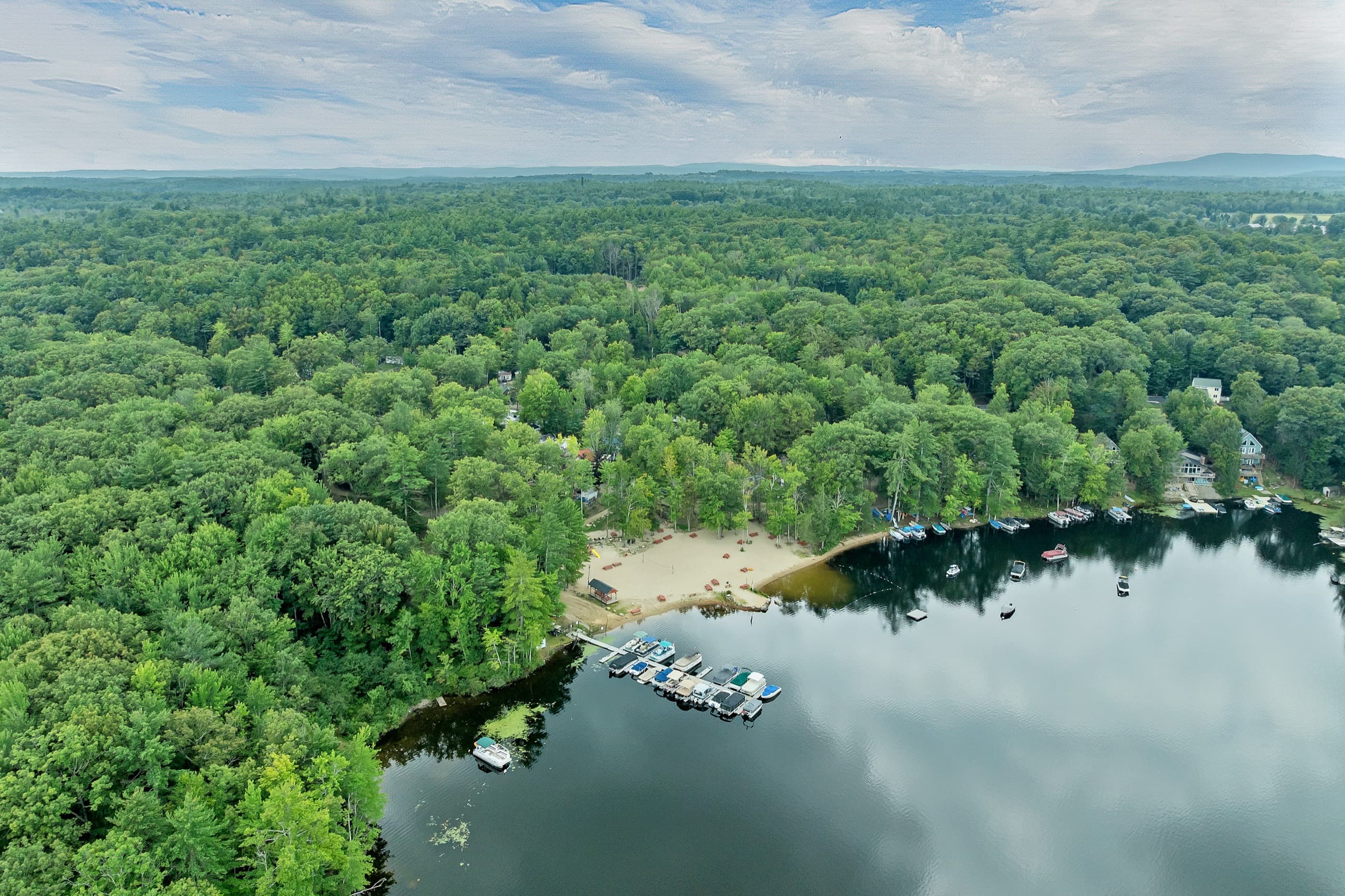 Aerial view of the community beach on Baxter Lake, with the docks and boats